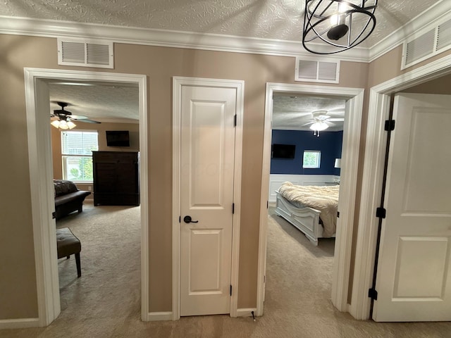150 Shawnee Dr, Pickerington, OH 43147 - hall featuring light carpet, a textured ceiling, crown molding, and a chandelier