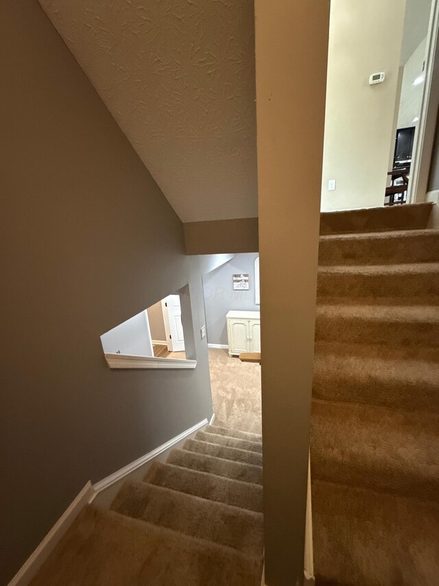 150 Shawnee Dr, Pickerington, OH 43147 - staircase with carpet, a textured ceiling, baseboards, and vaulted ceiling