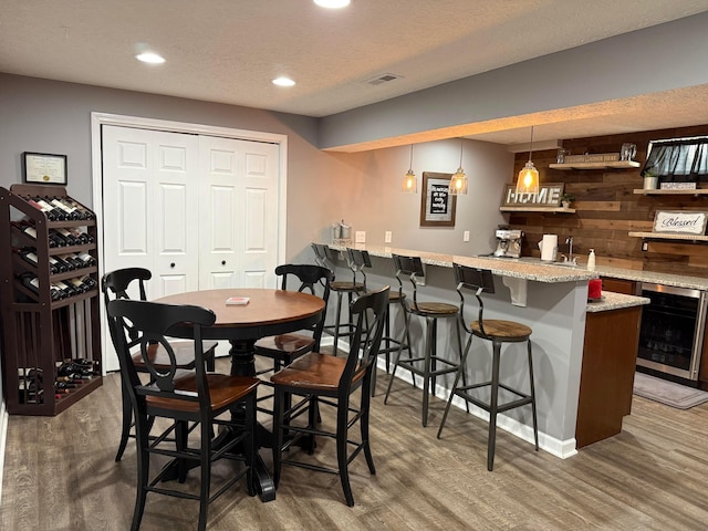150 Shawnee Dr, Pickerington, OH 43147 - dining room featuring beverage cooler, wet bar, wood finished floors, recessed lighting, and baseboards