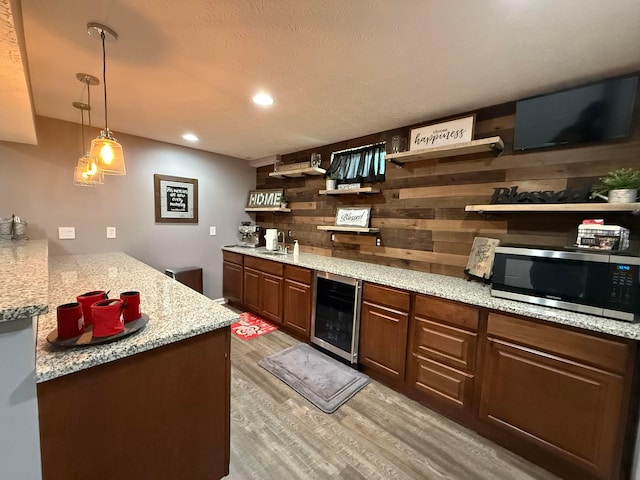 150 Shawnee Dr, Pickerington, OH 43147 - bar area with stainless steel microwave, wine cooler, light wood-style flooring, a sink, and recessed lighting