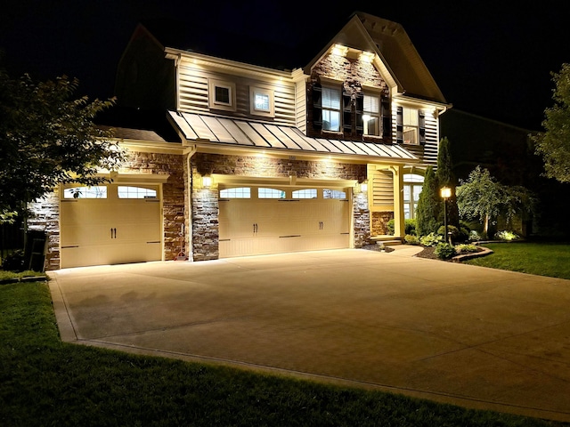150 Shawnee Dr, Pickerington, OH 43147 - craftsman house featuring a standing seam roof, stone siding, driveway, an attached garage, and metal roof