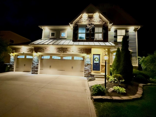 150 Shawnee Dr, Pickerington, OH 43147 - craftsman inspired home featuring a standing seam roof, stone siding, an attached garage, driveway, and metal roof