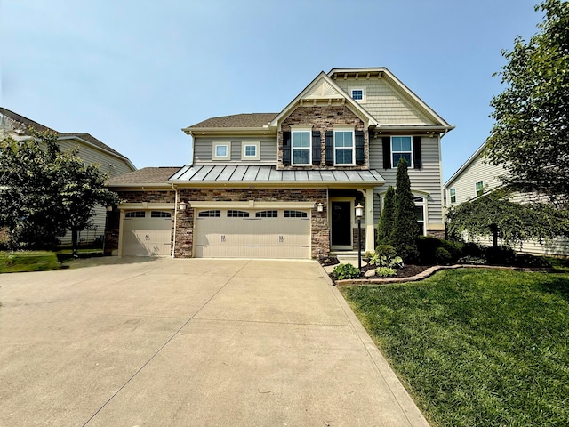 150 Shawnee Dr, Pickerington, OH 43147 - craftsman-style house with concrete driveway, a front yard, stone siding, a standing seam roof, and a garage
