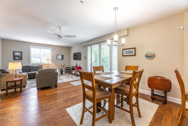 10 E Weber Rd Unit 205, Columbus, OH 43202 - dining area with wood finished floors, a chandelier, ceiling fan, and baseboards