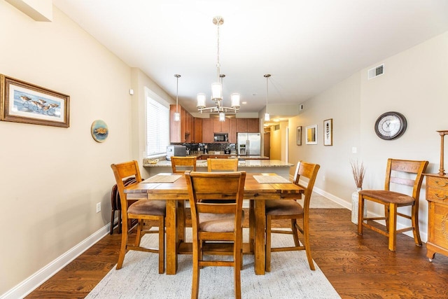 10 E Weber Rd Unit 205, Columbus, OH 43202 - dining area with light wood-style floors, baseboards, and a chandelier