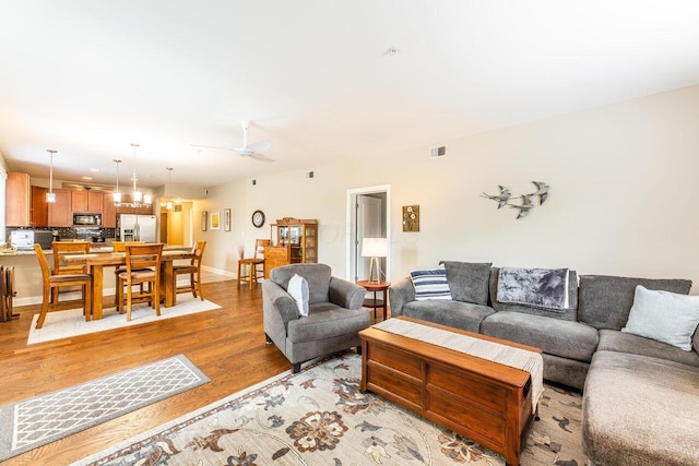 10 E Weber Rd Unit 205, Columbus, OH 43202 - living area with light wood-style floors, baseboards, and ceiling fan
