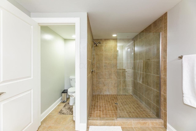 10 E Weber Rd Unit 205, Columbus, OH 43202 - bathroom with toilet, tiled shower, tile patterned floors, recessed lighting, and baseboards