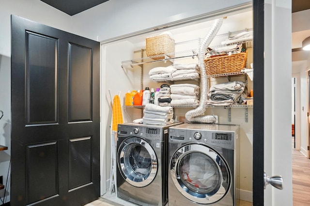 158 Punta Aly, Columbus, OH 43201 - laundry area featuring washing machine and clothes dryer, wood finished floors, and baseboards