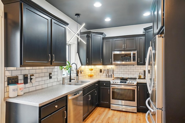 158 Punta Aly, Columbus, OH 43201 - kitchen with appliances with stainless steel finishes, a sink, tasteful backsplash, light countertops, and recessed lighting