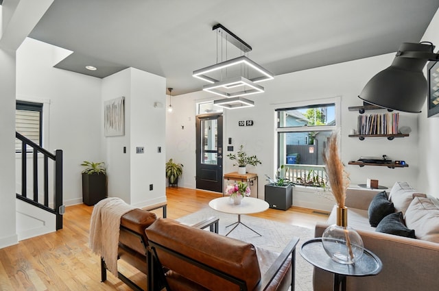 158 Punta Aly, Columbus, OH 43201 - living room featuring light wood-type flooring, stairway, a chandelier, and baseboards