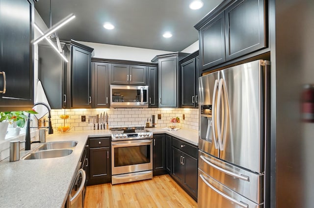 158 Punta Aly, Columbus, OH 43201 - kitchen with appliances with stainless steel finishes, a sink, light wood finished floors, tasteful backsplash, and recessed lighting