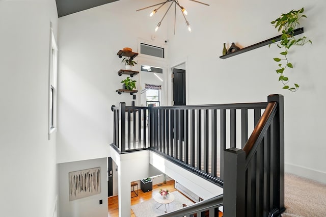 158 Punta Aly, Columbus, OH 43201 - staircase featuring a chandelier, baseboards, and a towering ceiling