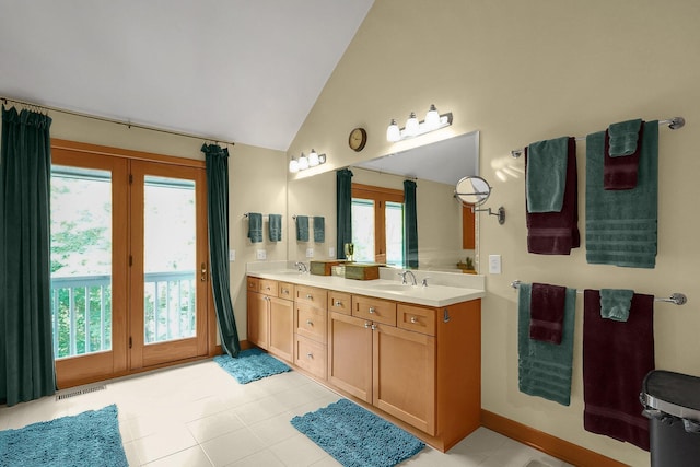 3850 Alward Rd SW, Pataskala, OH 43062 - full bathroom featuring vaulted ceiling, double vanity, plenty of natural light, tile patterned floors, and baseboards