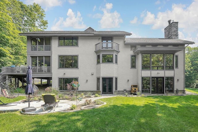 3850 Alward Rd SW, Pataskala, OH 43062 - back of house with french doors, a balcony, stucco siding, a patio area, and a lawn