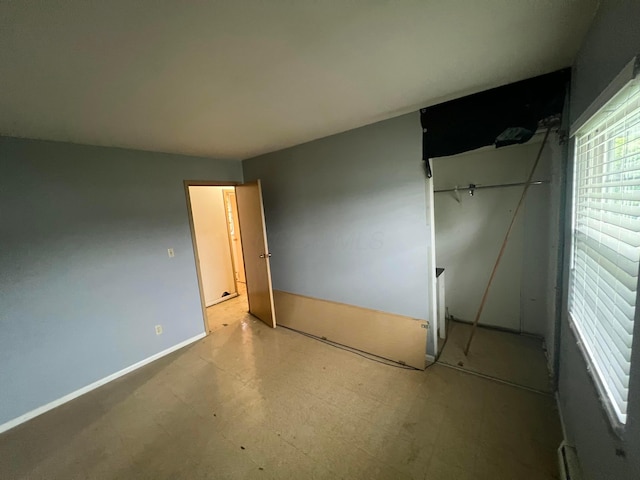 5340 Edgeview Rd, Columbus, OH 43207 - unfurnished bedroom with tile patterned floors, baseboards, and a closet