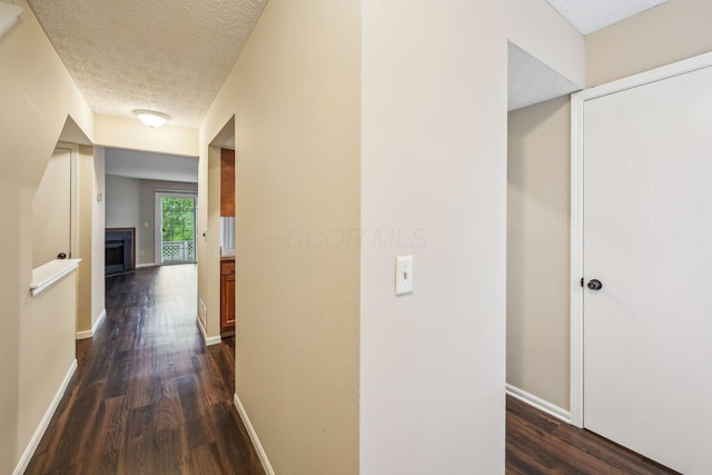 5905 Shadow Lake Cir, Columbus, OH 43235 - hall featuring dark wood-style flooring, baseboards, and a textured ceiling