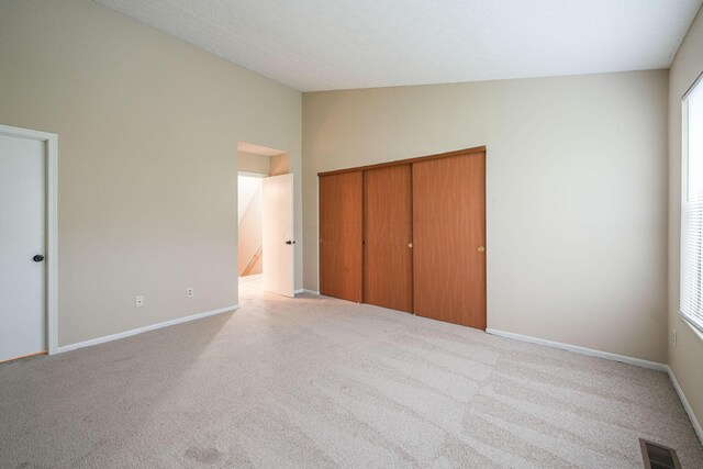 5905 Shadow Lake Cir, Columbus, OH 43235 - unfurnished bedroom featuring vaulted ceiling, carpet, a closet, and baseboards