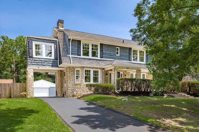 320 Rhoads Ave, Columbus, OH 43205 - shingle-style home with a chimney, stone siding, an outdoor structure, and driveway