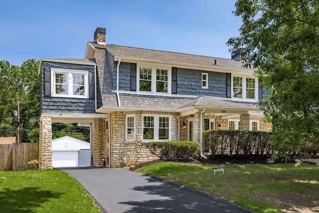 320 Rhoads Ave, Columbus, OH 43205 - shingle-style home with a chimney, an outbuilding, stone siding, and asphalt driveway