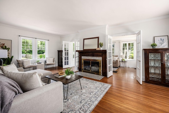 320 Rhoads Ave, Columbus, OH 43205 - living area with ornamental molding, healthy amount of natural light, wood finished floors, a brick fireplace, and french doors