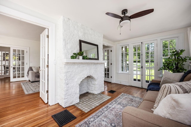 320 Rhoads Ave, Columbus, OH 43205 - living area featuring french doors, wood finished floors, a ceiling fan, and a stone fireplace