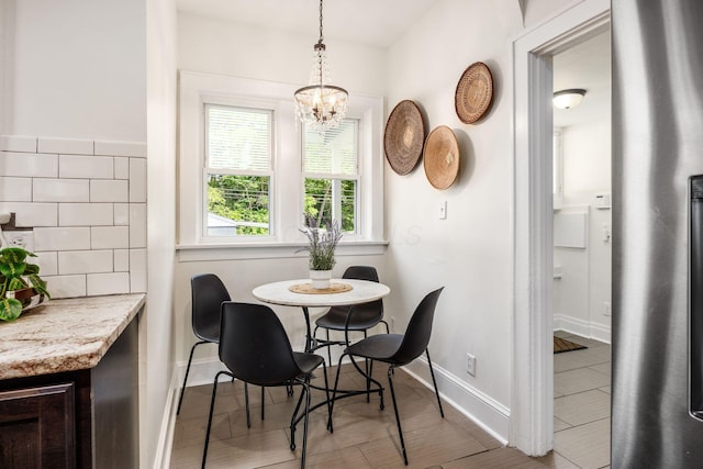 320 Rhoads Ave, Columbus, OH 43205 - dining room featuring baseboards, a chandelier, and wood finished floors