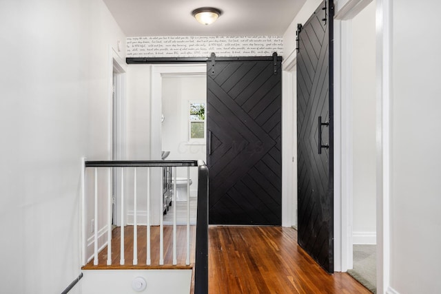 320 Rhoads Ave, Columbus, OH 43205 - entrance foyer featuring a barn door, wood finished floors, and baseboards