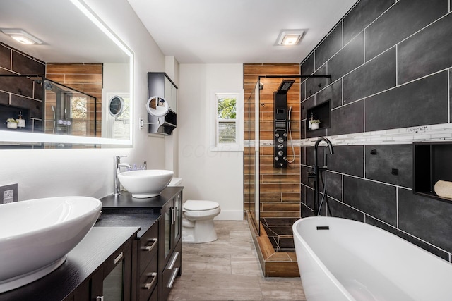 320 Rhoads Ave, Columbus, OH 43205 - full bath featuring a shower stall, double vanity, a freestanding tub, and toilet