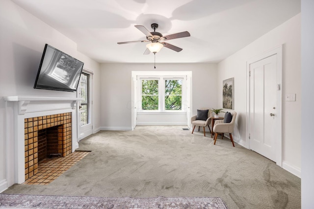 320 Rhoads Ave, Columbus, OH 43205 - living area featuring carpet flooring, a ceiling fan, a tiled fireplace, and baseboards