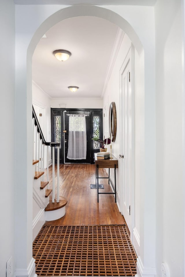 320 Rhoads Ave, Columbus, OH 43205 - entrance foyer featuring ornamental molding, stairs, wood finished floors, arched walkways, and baseboards