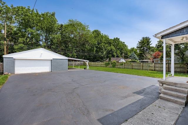 320 Rhoads Ave, Columbus, OH 43205 - view of patio featuring a garage, an outbuilding, and view of scattered trees