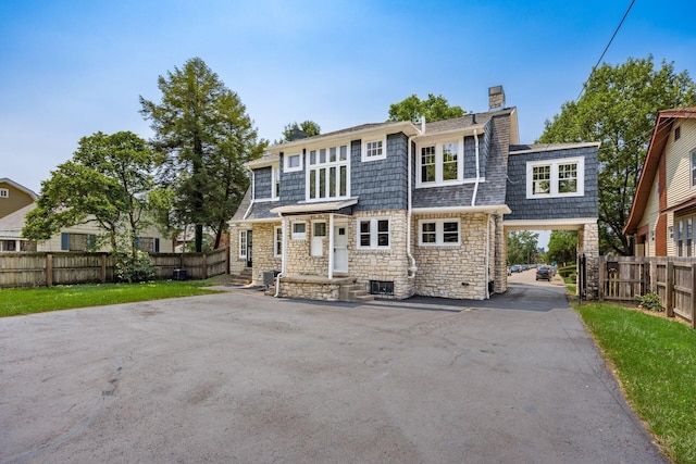 320 Rhoads Ave, Columbus, OH 43205 - view of front facade with a chimney, stone siding, and a shingled roof