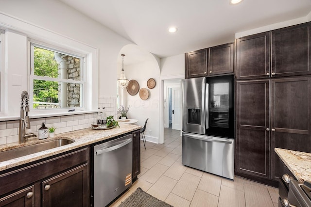 320 Rhoads Ave, Columbus, OH 43205 - kitchen with appliances with stainless steel finishes, a sink, tasteful backsplash, dark brown cabinets, and recessed lighting