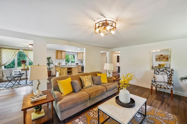 135 State Route 229, Waldo, OH 43356 - living area with plenty of natural light, dark wood-type flooring, baseboards, and a chandelier