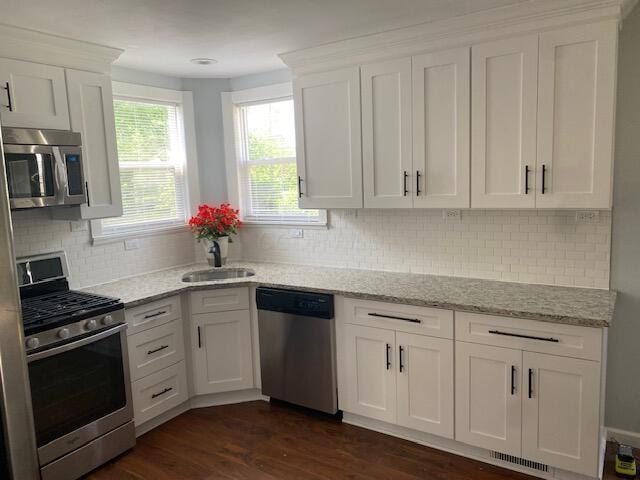 2691 Howey Rd, Columbus, OH 43211 - kitchen featuring stainless steel appliances, a sink, white cabinets, and tasteful backsplash