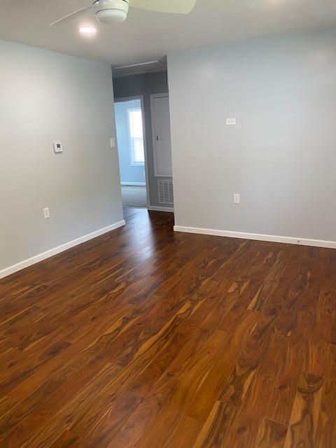 2691 Howey Rd, Columbus, OH 43211 - empty room featuring dark wood-style floors, baseboards, and a ceiling fan