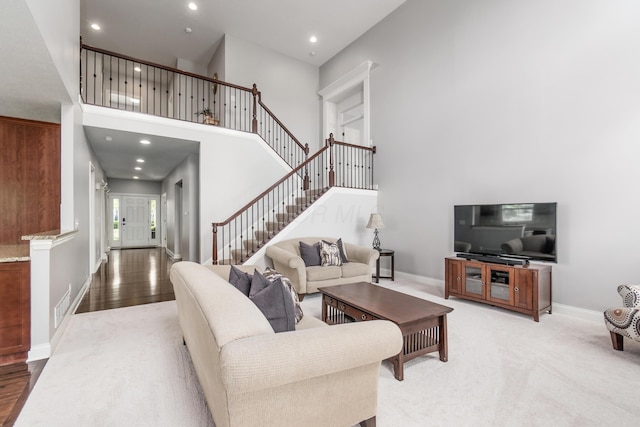 7685 Skarlocken Grn, New Albany, OH 43054 - living room with stairway, recessed lighting, and a towering ceiling