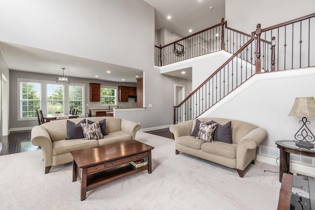7685 Skarlocken Grn, New Albany, OH 43054 - living area with a high ceiling, recessed lighting, stairway, and carpet