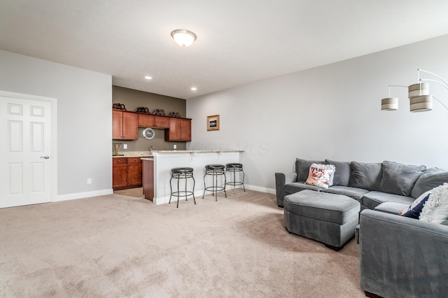 7685 Skarlocken Grn, New Albany, OH 43054 - living room with bar with sink, light colored carpet, and recessed lighting