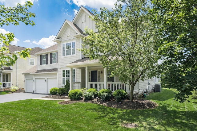 7685 Skarlocken Grn, New Albany, OH 43054 - view of front facade with a porch, driveway, board and batten siding, a front lawn, and an attached garage