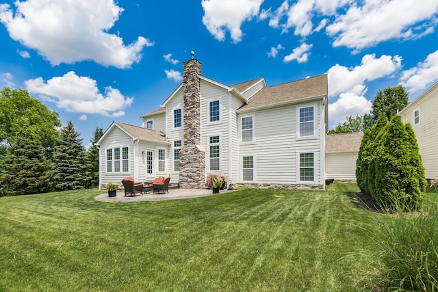 7685 Skarlocken Grn, New Albany, OH 43054 - back of property with a patio area, a lawn, a chimney, and stone siding