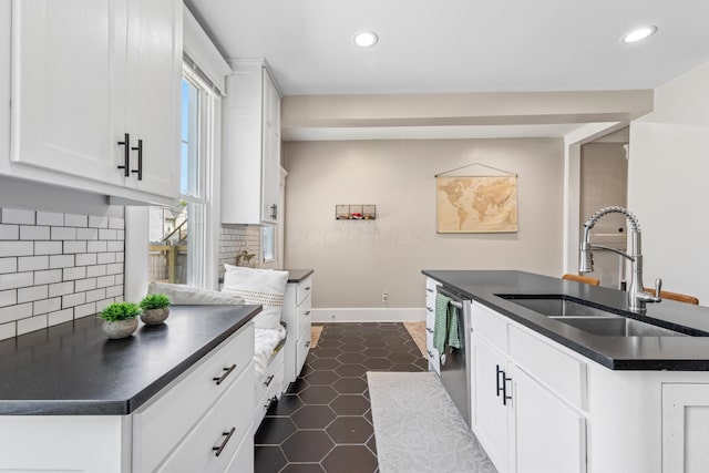 1140 Summit St, Columbus, OH 43201 - kitchen featuring dark countertops, a sink, dishwasher, recessed lighting, and backsplash