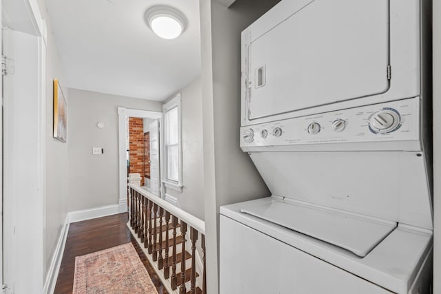 1140 Summit St, Columbus, OH 43201 - laundry room featuring stacked washing machine and dryer, baseboards, and dark wood finished floors