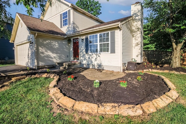 3476 Bayspirit Ct, Reynoldsburg, OH 43068 - traditional-style house with a chimney, an attached garage, and asphalt driveway