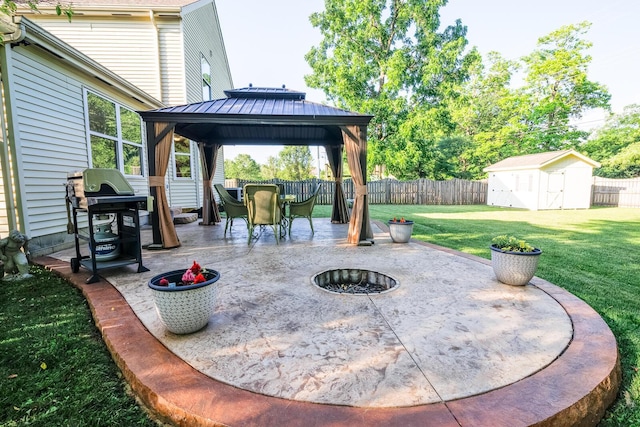 3476 Bayspirit Ct, Reynoldsburg, OH 43068 - fenced backyard with a gazebo, an outdoor fire pit, area for grilling, a shed, and a patio area