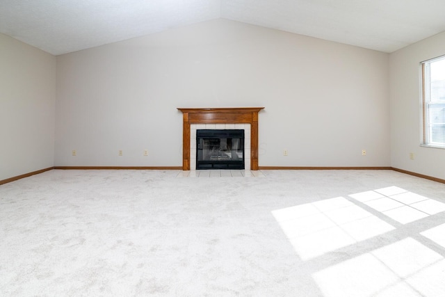 3476 Bayspirit Ct, Reynoldsburg, OH 43068 - unfurnished living room featuring light carpet, vaulted ceiling, and a tile fireplace