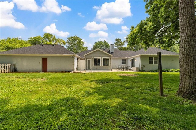 685 Hawthorne Dr, Circleville, OH 43113 - rear view of house with a patio area, a chimney, and a lawn