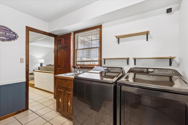 685 Hawthorne Dr, Circleville, OH 43113 - washroom featuring cabinet space, separate washer and dryer, and light tile patterned flooring