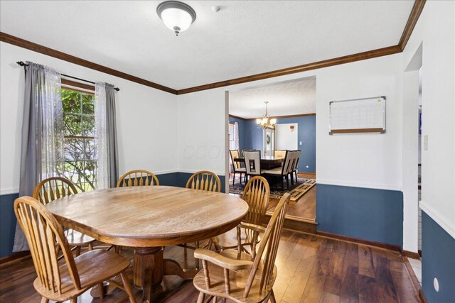 685 Hawthorne Dr, Circleville, OH 43113 - dining room featuring dark wood finished floors, crown molding, a chandelier, and baseboards