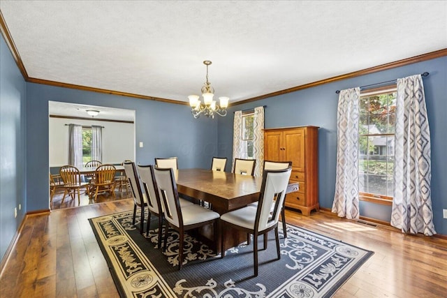685 Hawthorne Dr, Circleville, OH 43113 - dining area featuring a chandelier, hardwood / wood-style flooring, crown molding, baseboards, and a textured ceiling